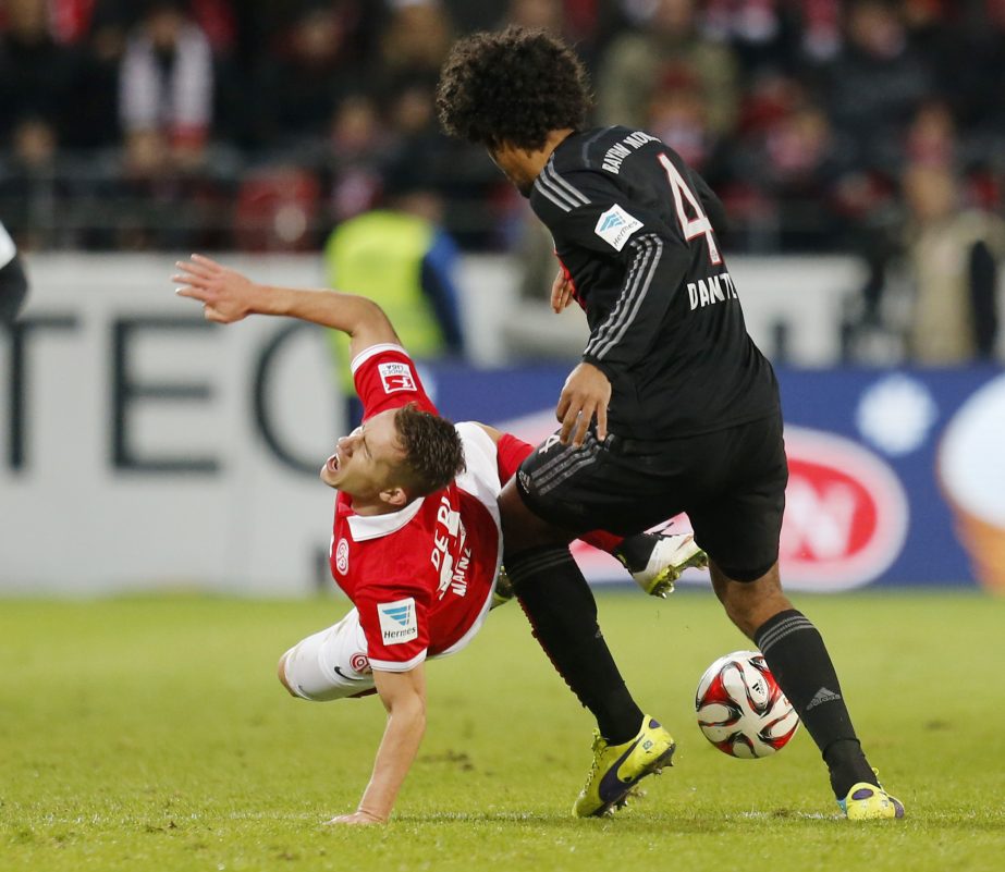 Mainzâ€™s Pablo de Blasis from Argentina (left) and Bayern's Dante from Brazil challenge for the ball during the German first division Bundesliga soccer match between FSV Mainz 05 and Bayern Munich in Mainz, Germany on Friday.