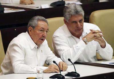 Cuba's President Raul Castro (L) speaks with his first vice-president Miguel Diaz Canel during a session of the National Assembly in Havana.