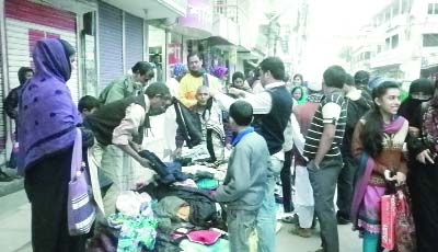SIRAJGANJ: People are busy in buying winter clothes at SS Road in Sirajganj yesterday.