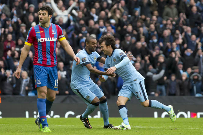 Manchester City's David Silva (right) celebrates with teammate Fernandinho after scoring against Crystal Palace during the English Premier League soccer match between Manchester City and Crystal Palace at the Etihad Stadium, Manchester, England on Saturd