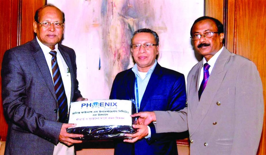 Deputy Managing Director of Phoenix Finance & Investments Limited, Dr M Shah Alam handing over blankets to the General Manager of Bangladesh Bank, AFM Asaduzzaman for distribution among the cold affected people. Senior Principal Officer Md Shahzada Selim