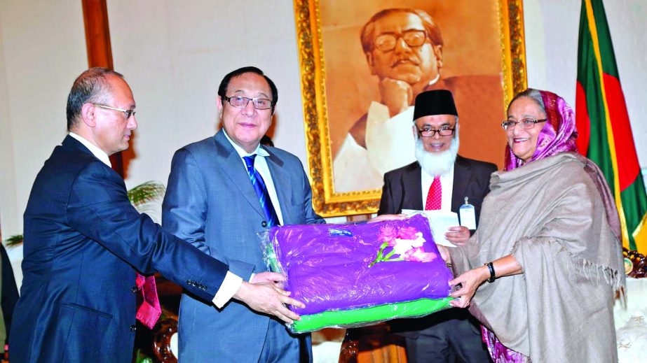 Prime Minister Sheikh Hasina receiving blankets from A Rouf Chowdhury, Chairman of Bank Asia and Rumee A Hossain, Chairman of Executive Committee of the bank at Ganobhaban on Saturday. Bank Asia donated 25,000pcs of blankets to the Prime Minister's Relie