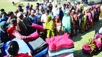 GAIBANDHA: Prothom Alo Trust distributing warm clothes among the cold -hit people at Asaduzzaman School and College premises on Sunday.