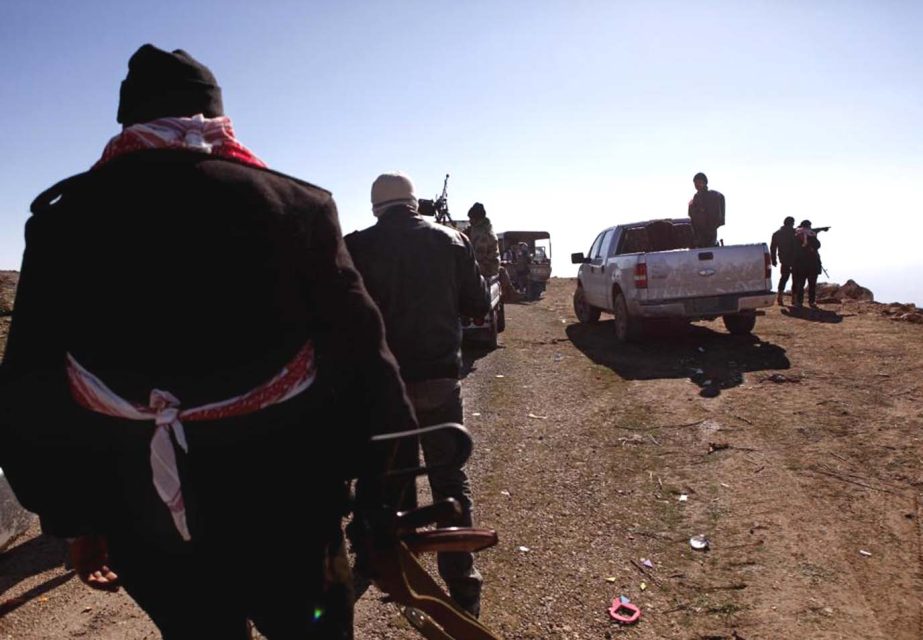 Iraqi Kurdish forces head to battle Islamic State militants on the summit of Mount Sinjar, in Iraq on Monday.