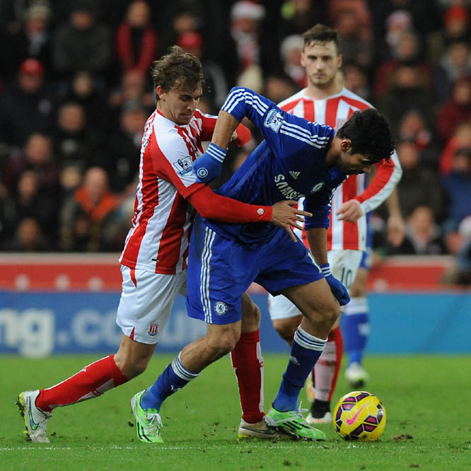Stoke's Marc Muniesa (left) contest the ball with Chelsea's Diego Costa during the English Premier League soccer match between Stoke City and Chelsea at the Britannia Stadium, in Stoke on Trent, England on Monday.
