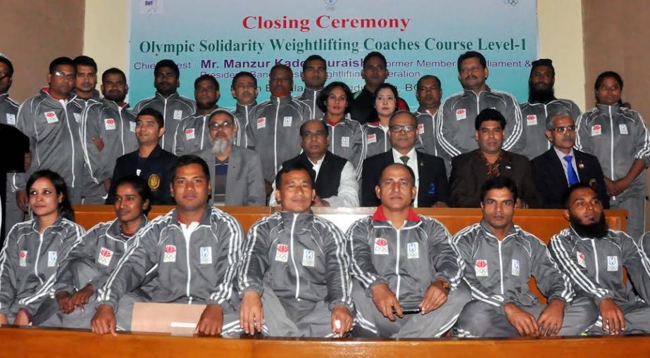 Participants of the Olympic Solidarity Wetlifting Coaching Coaches Course level-1 which concluded on Tuesday pose for photo with guests at the Bangladesh Olympic Association (BOA) Auditorium.