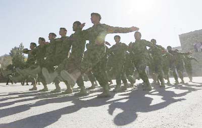 New members of the Afghan National Army march during their graduation ceremony at the Afghan Military Academy in Kabul, Afghanistan.