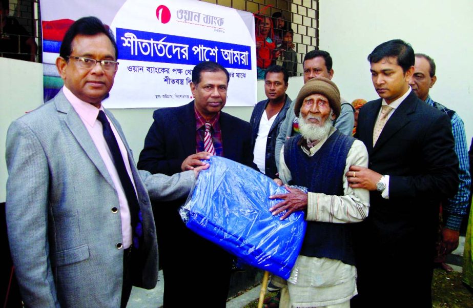 Khandaker Liakat Ali, Vice-President of ONE Bank Limited, distributing blankets among the cold stricken poor at Aushtagram, Kishoreganj recently. Shahidul Islam (James), Upazila Chairman of Aushtagram was present.