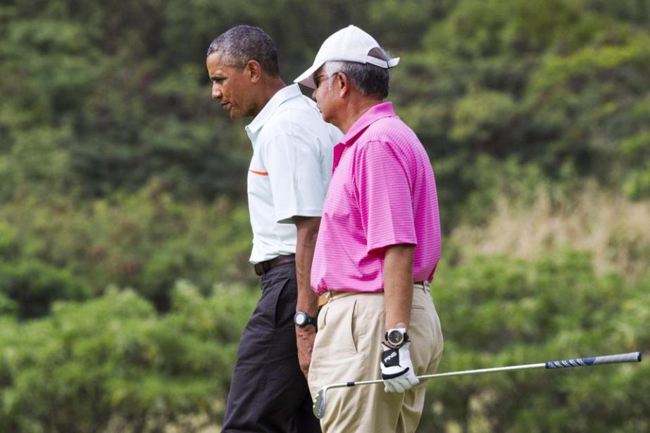 President Barack Obama plays golf with Malaysian Prime Minister Najib Razak (right) on Wednesday at Marine Corps Base Hawaii's Kaneohe Klipper Golf Course in Kaneohe, Hawaii during the Obama family vacation.