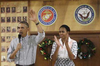 US President Barack Obama and First Lady Michelle Obama Â® greet US military personnel at Marine Corps Base Hawaii on Christmas Day in Kaneohe Bay, Hawaii