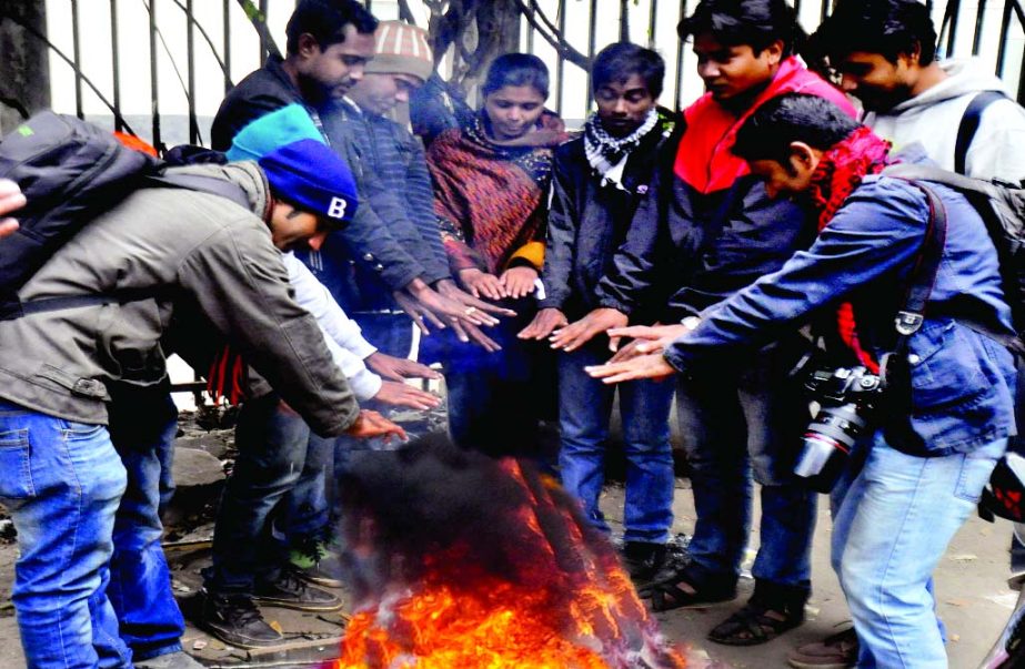 Cold-hit people getting warmth around the fire as the cold chill sweeps in the city suddenly. The snap was taken from in front of the National Press Club on Friday.