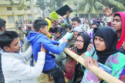 BOGRA: A child is being received by her guardian after appearing at the admission test. This picture was taken from Bogra Zilla School centre on Friday.