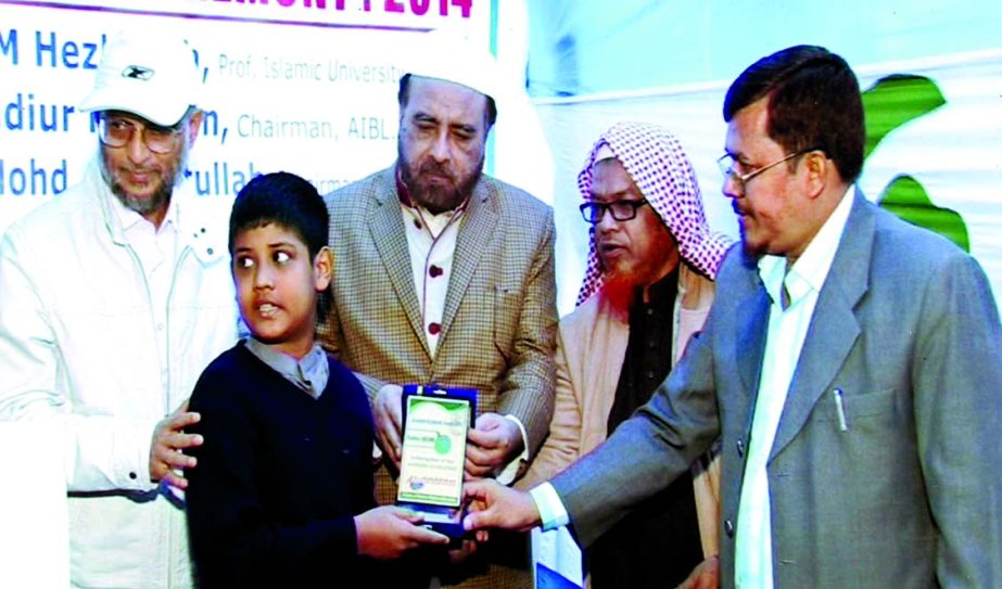 Dr Hafez ABM Hezbullah, Prof of Islamic University, Kushtia, distributing prizes among the students of Al-Arafah Islamic International School and College at the school premises recently. Badiur Rahman, Chairman of Al-Arafah Islami Bank Ltd was present as