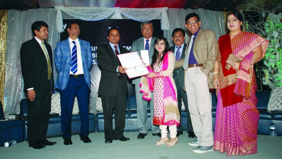 A meritorious student receiving certificate and award from AHM Mustafa Kamal FCA, MP, Minister, Ministry of Planning at a function organized by the Institute of Chartered Accountants of Bangladesh at its auditorium recently. Among others, ICAB President S