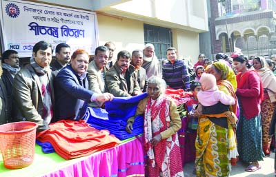 DINAJPUR: Executives of Dinajpur Chamber of Commerce and Industry distributing blankets among cold-hit people in Dinajpur town on Tuesday.