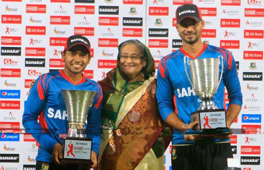 Prime Minister Sheikh Hasina, Test captain Mushfiqur Rahim and ODI captain Mashrafe Bin Mortaza posing for a photograph with the tournament trophies after the final ODI against Zimbabwe at the Sher-e-Bangla National Cricket Stadium in the capital on Dec