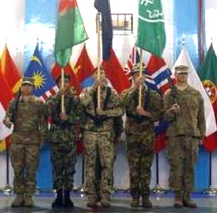 Afghan and NATO-led International Security Assistance Force soldiers stand during the change of mission ceremony in Kabul on Tuesday.