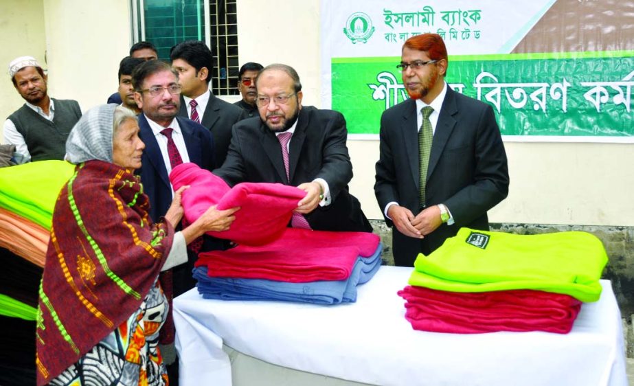 Mohammad Abdul Mannan, Managing Director of Islami Bank Bangladesh Limited distributing blankets among the cold affected destitute in the city at the bank's head office on Wednesday. Abdus Sadeque Bhuiyan, EVP and Head of Development Wing and AHM Latif U