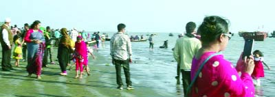 KUAKATA(Patuakhali): Tourists enjoining natural beauty at Kuakata sea beach. This picture was taken on Wednesday.