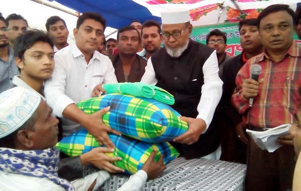 Former CCC mayor and Chittagong City Awami League President Alhaj ABM Mohiuddin Chowdhury distributing relief goods among the fire victims at Chhotopul area recently.