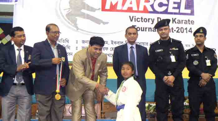 Additional Director of RB Group FM Iqbal Bin Anwar Dawn shaking hands with a winner of the Marcel Victory Day Karate Competition at the Shaheed Suhrawardy Indoor Stadium in Mirpur on Thursday.