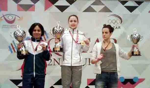 Molla Sabira Sultana (left) showing her silver medal of the Women's Division of the Qatar 2nd International Weightlifting Competition at the Al Saad Sports Club in Doha, the capital city of Qatar on Wednesday.