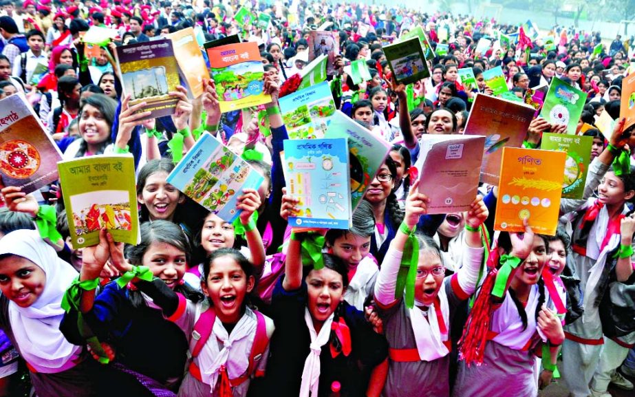 Students of Motijheel Government Boysâ€™ and Girls' High School rejoicing after receiving new books distributed by Education Minister Nurul Islam Nahid on first day of New Year 2015.