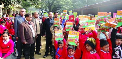 CHAPAINAWABGANJ: Students showing their new books with joyous mood at Govt Model Primary School in Chapainawabganj on Thursday.