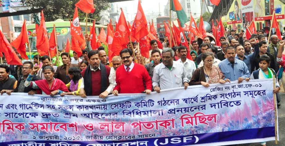 National Garment Workers Federation brought out a procession in the city on Friday demanding formulation of rules of Labour Law.