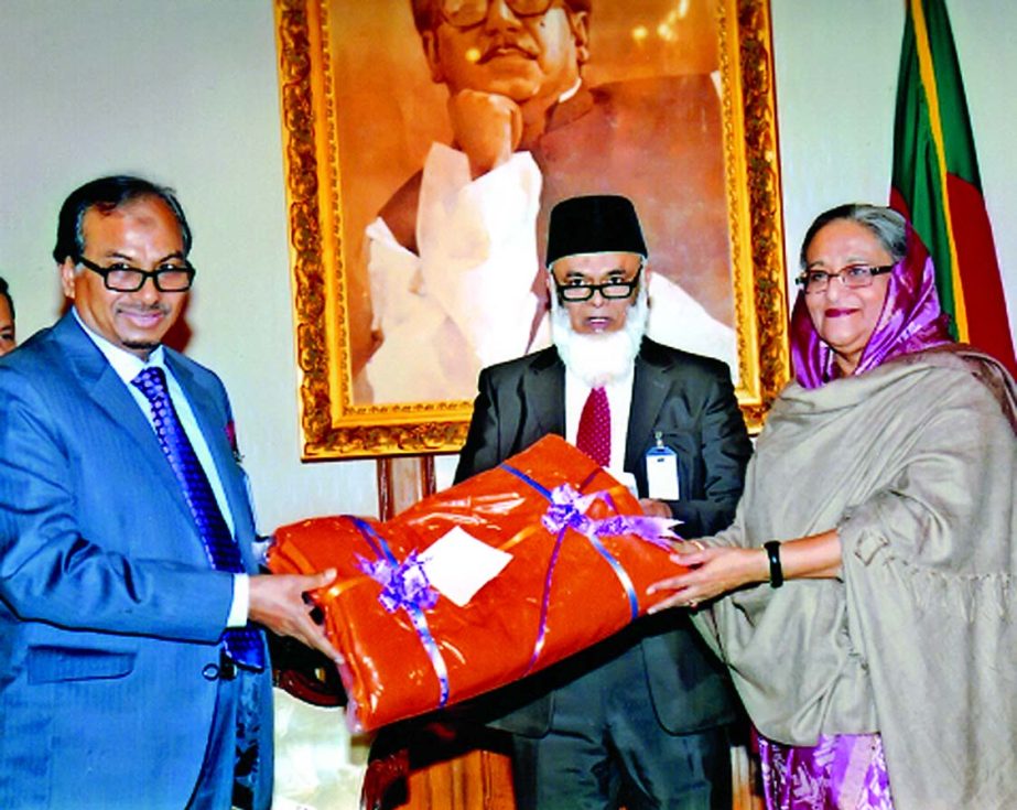 Prime Minister Sheikh Hasina receiving blankets from Nur Mohammed, Chairman of Jamuna Bank Foundation to PM's Relief and Welfare Fund for distributing among the cold affected poor of the country at Ganobhaban recently.