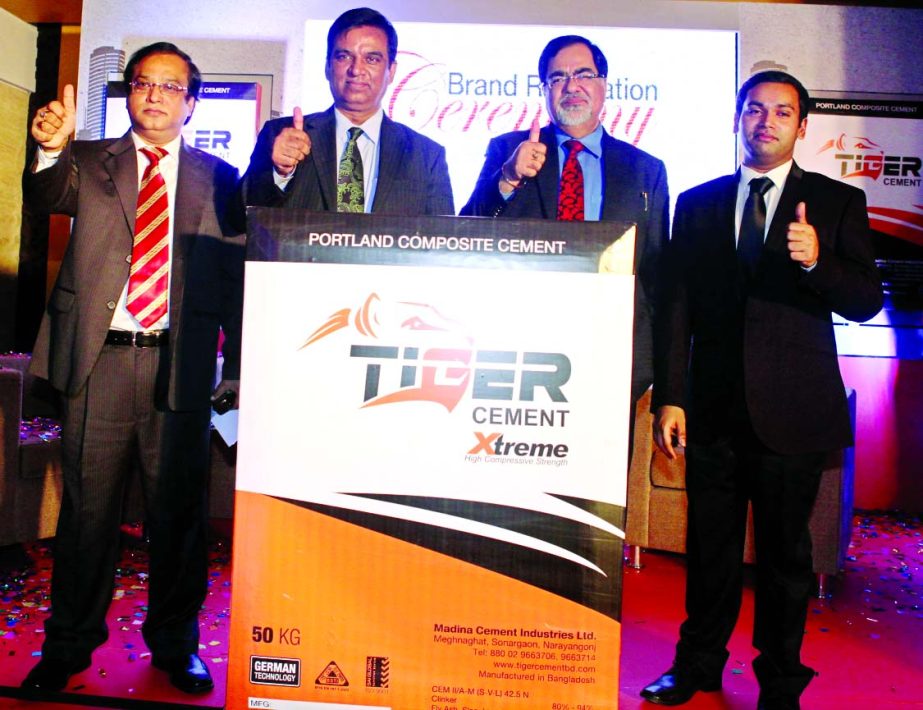 Haji Mohammad Salim, Managing Director of Madina Cement Industries Ltd, unveiling the plaque of new logo and packs of Tiger Cement and Tiger Cement Xtreme at a city hotel Saturday. Ashok Kumar Dembla, MD of Enexco Technologies Ltd, a sister concern of Beu