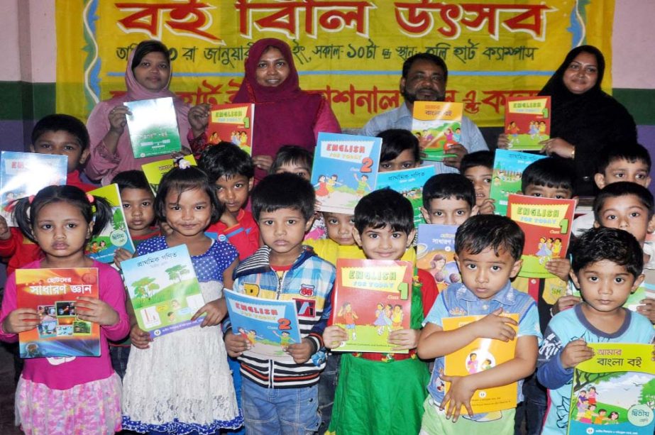 Students with teachers and parents rejoicing while receiving textbooks on the occasion of Textbook Festival at Holy Heart Int'l School and College in the city on Saturday.