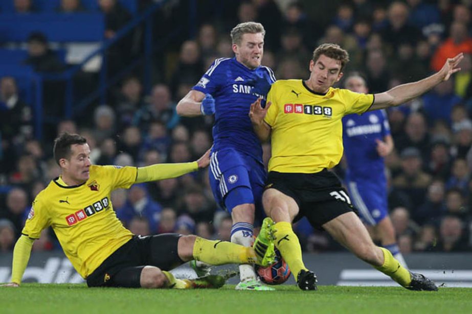 Chelseaâ€™s Andre Schurrle (centre) tussles with Watfordâ€™s Daniel Tozser (left) and Tommie Hoban during their English FA Cup third round soccer match between Chelsea and Watford at Stamford Bridge in London, England on Sunday.