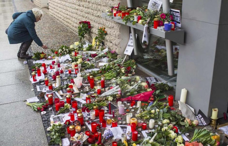 A woman places flowers of condolance at the French embassy at Pariser Platz in Berlin on Thursday.