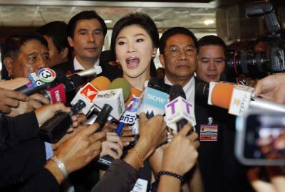 Thailand's former Prime Minister Yingluck Shinawatra, center, talks to reporters on her arrival at parliament in Bangkok, Thailand on Friday.