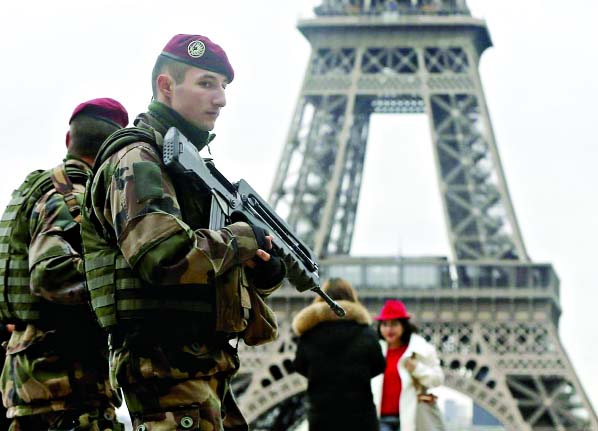 French soldier patrol near the Eiffel Tower in Paris as part of the highest level of "Vigipirate"" security plan after a shooting at the Paris offices of Charlie Hebdo on January 9."