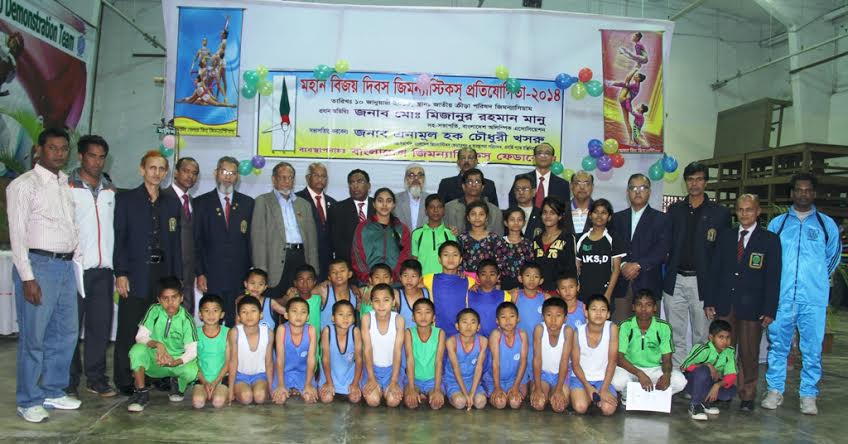 The winners of the Victory Day Gymnastics Competition with the guests and officials of Bangladesh Gymnastics Federation pose for a photo session at the Gymnasium of National Sports Council on Saturday.