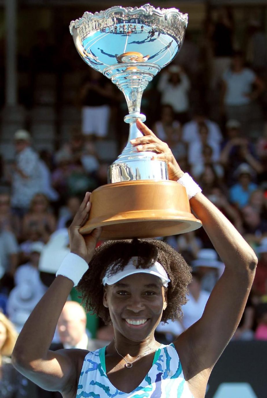 Venus Williams of the US celebrates with the trophy after beating Caroline Wozniacki of Denmark during their women's singles final at the ASB Classic tennis tournament in Auckland on Saturday.