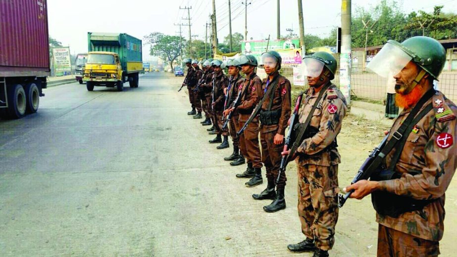 Members of BGB stand guard on Dhaka-Chittagong Highway to evert any untoward incident during blockade on Saturday.