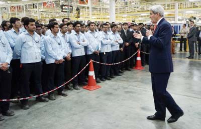 US Secretary of State John Kerry talks to workers at a soon-to-be opened Ford India automotive factory in Sanand on Monday.