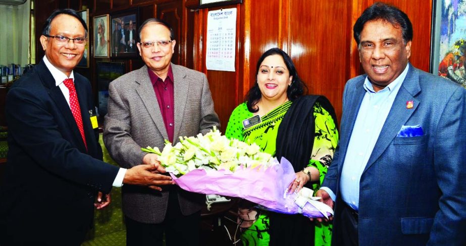 Bangladesh Bank Governor Dr Atiur Rahman greeted with bouquet by Rotary Governor Safina Rahman at his office for awarding Best Central Bank Governor for Asia Pacific on Sunday. Rtn Aftab Ul Islam and Secretary General of AMTOB Rtn TIM Nurul Kabir were pr