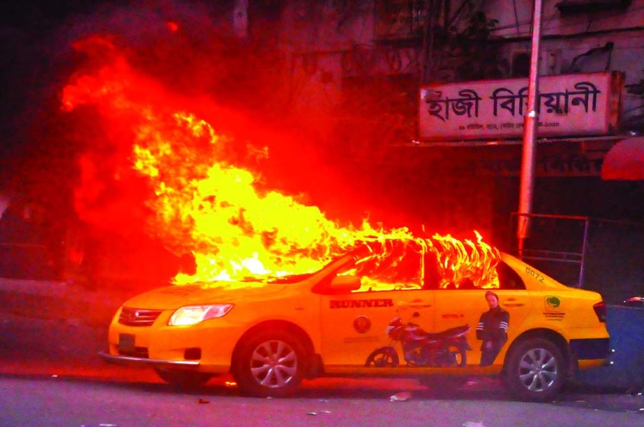 Picketers set a taxicab on fire during continued blockade in city's Motijheel area on Tuesday evening.