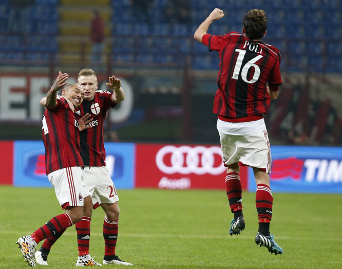 AC Milan's Nigel de Jong (left) celebrates with his teammates Ignazio Abate (center) and AC Milan's Andrea Poli after scoring during the Italian Cup soccer match between AC Milan and Sassuolo at the San Siro stadium in Milan, Italy on Tuesday.