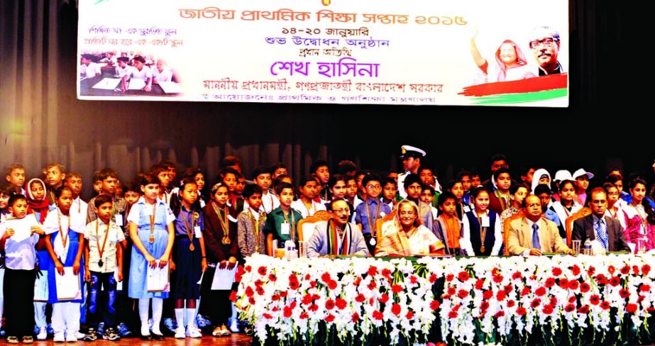 Prime Minister Sheikh Hasina seen with the recipients of Primary School students on the occasion of National Primary Education Week-2015 at Osmani Smrity auditorium in the city on Wednesday.