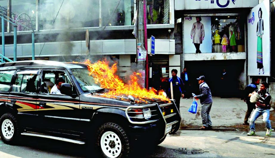 Pajero jeep being torched by blockaders at Dhanmondi Road No 27 near a market on Wednesday.