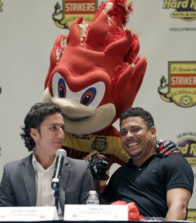 Three-time FIFA player of the year Ronaldo LuÃ­s Nazario de Lima (right) laughs as Fort Lauderdale Strikers mascot Hot Shot greets Ronaldo as Strikers co-owner Ricardo Geromel (left) looks on before a news conference on Wednesday in Hollywood, Fla. Rona