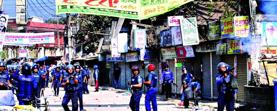 Police in action in front of BNP office at Kandirpar in Comilla Town during hartal hours on Thursday.