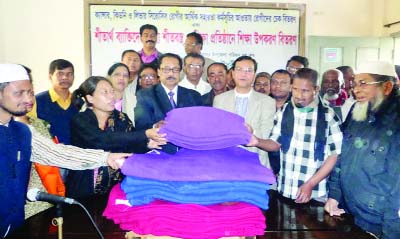 SYLHET: Mahamud Us Samad MP distributing winter clothes among the cold-hit people at South Surma Upazila Parishad auditorium recently.