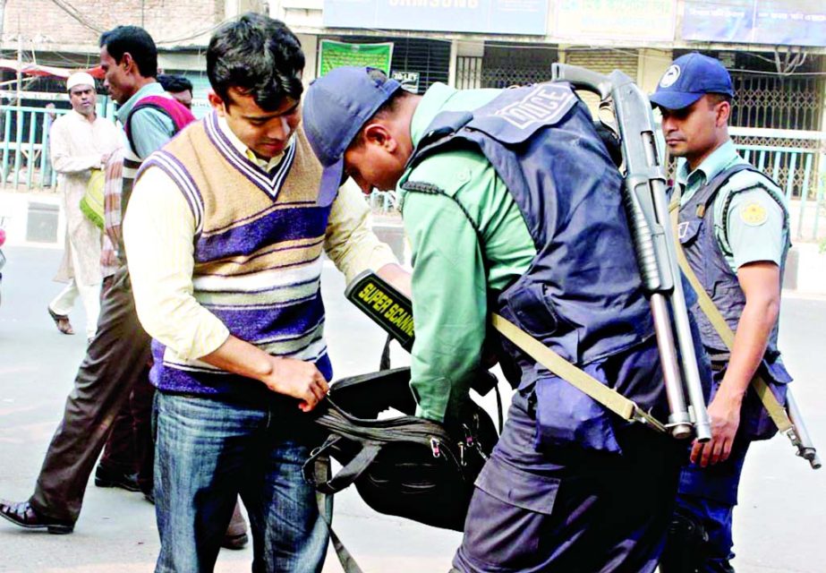 Law enforcers checking bags at the entrance of the Baitul Mokarram National Mosque to aevert any untoward incident. The snap was taken on Friday.