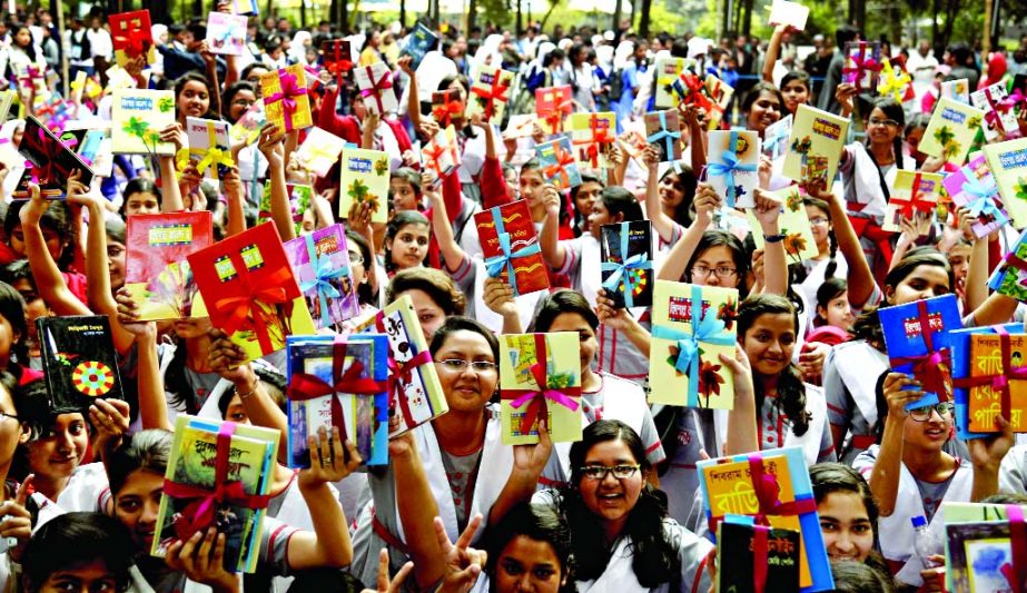Students rejoicing with new books at Ramna Batamul organised by Bishwa Sahittya Kendra on Friday.